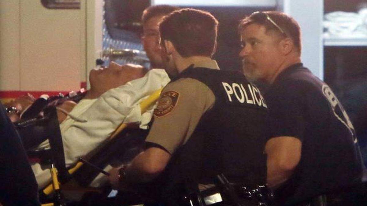
Paramedics took one of two police officers to a hospital after they were shot in Ferguson, Mo.
