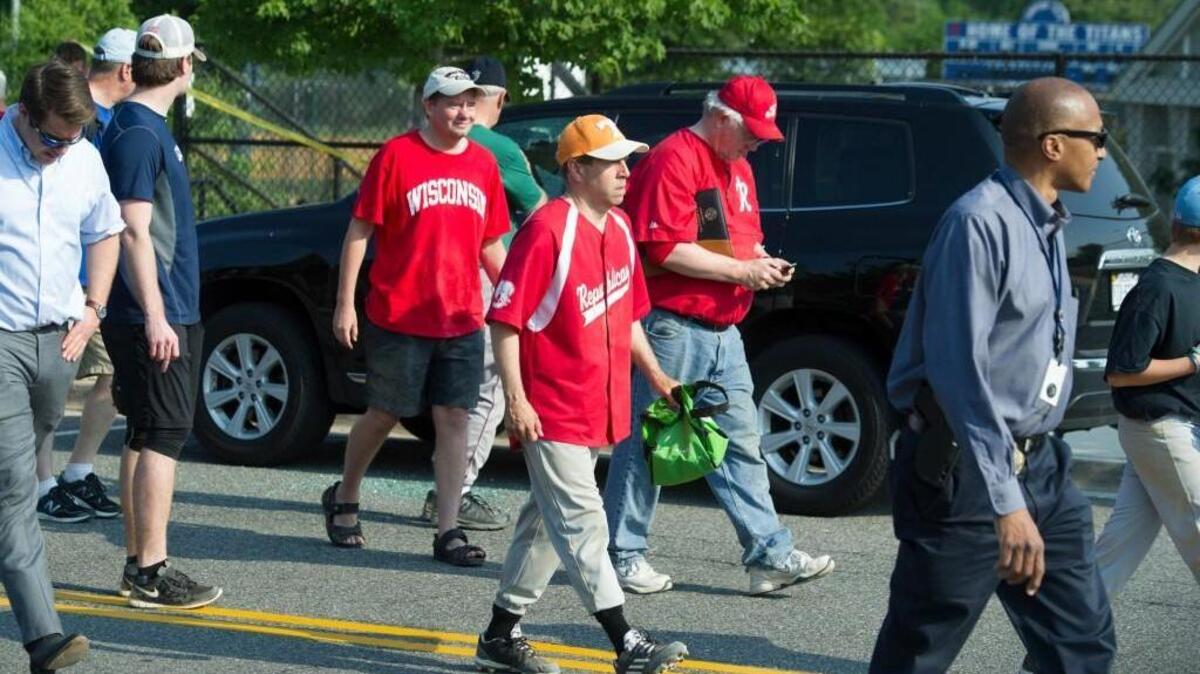 Rep. Chuck Fleichsmann, center, foreground, Rep. Joe Barton, manager of the Republican team, center, background, and others, leave the scene of a shooting in Alexandria, Va., Wednesday, June 14, 2017, where House Majority Whip Steve Scalise and others were shot during a Congressional baseball practice.