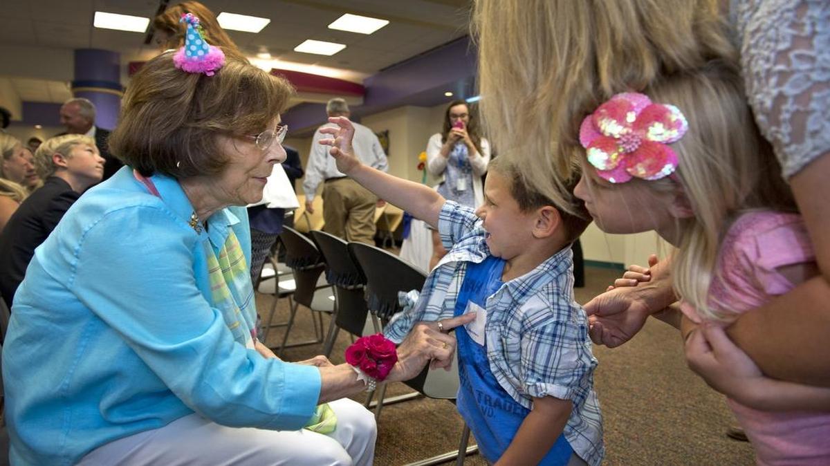 
Children's Mercy Hospital celebrated the fifth anniversary of the Elizabeth J. Ferrell Fetal Health Center on Thursday, with a surprise birthday party for Elizabeth Ferrell and the announcement of a new $2 million gift from the Ferrell family. The first child born in the high-risk center, Maddox Hodges (center), 4, of Oakley, Kan., got to meet Ferrell during the party.
