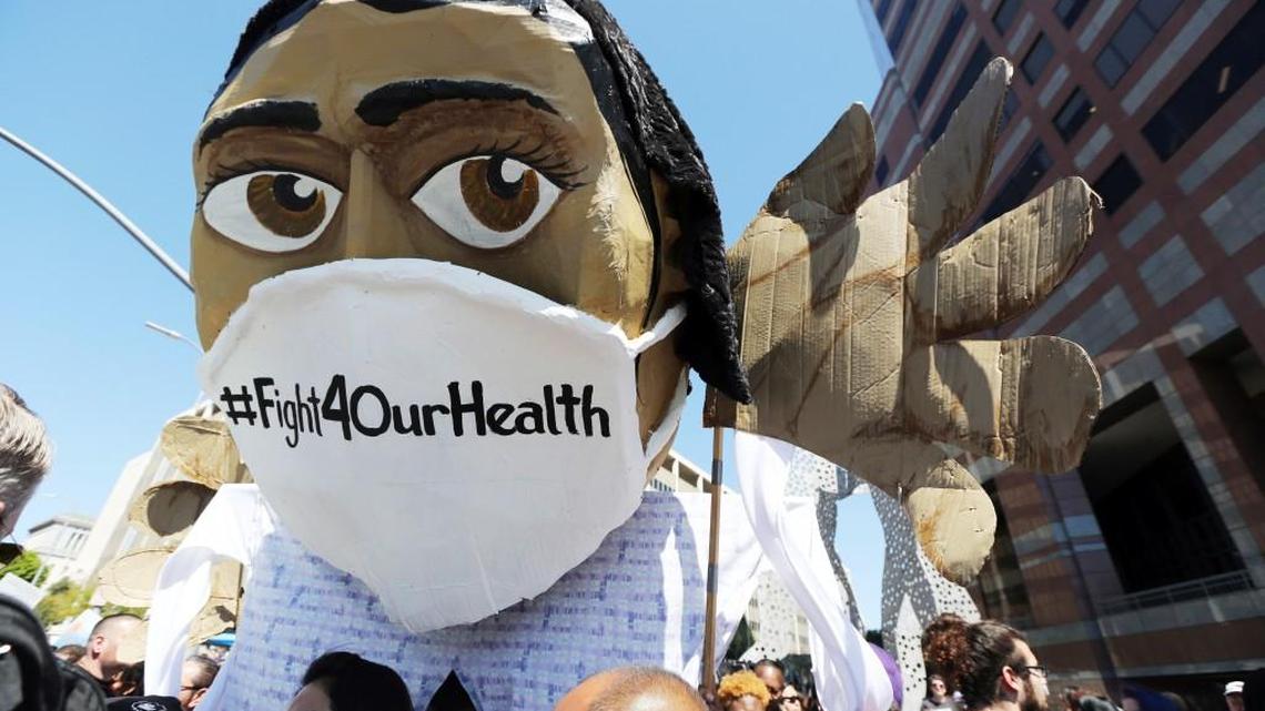 An oversize effigy of a health care professional is seen as hundreds of people march through downtown Los Angeles protesting President Donald Trump’s plan to dismantle the Affordable Care Act, his predecessor’s signature health care law, Thursday, March 23, 2017.