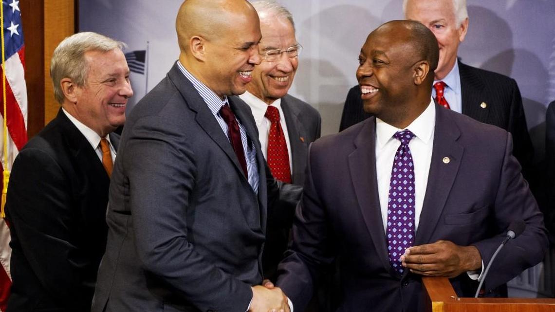 
The U.S. Senate’s two black members, Tim Scott, a South Carolina Republican (right), and Cory Booker, a New Jersey Democrat, helped carve the bipartisan criminal justice reform bill awaiting action from the body.
