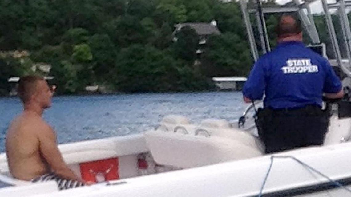 This photo by Myles Goertz shows Brandon Ellingson in the back of Trooper Anthony Piercy’s boat on May 31. Piercy later arrested Ellingson for boating while intoxicated, cuffed his hands behind his back and put a Type III life vest on him. Because a Type III vest has armholes, it cannot be secured on a handcuffed person. Troopers are trained to use Type I life jackets on handcuffed subjects. An orange-red Type I life jacket is visible in the boat a few feet from Ellingson.