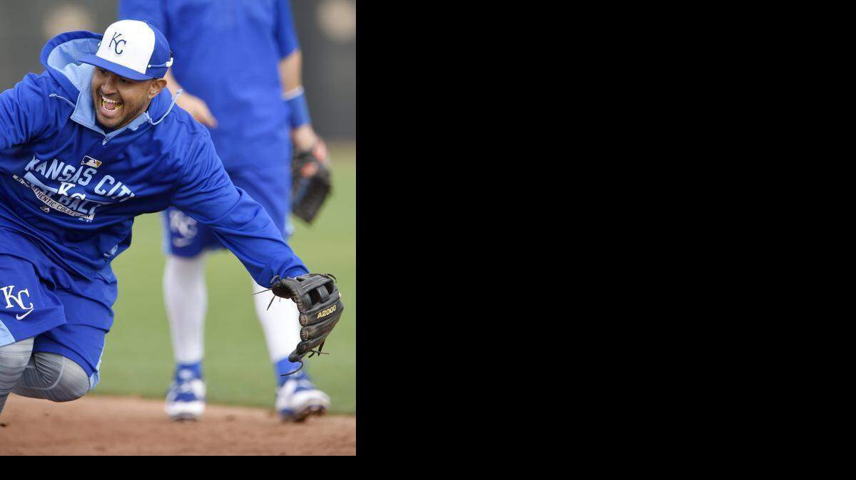 
Kansas City Royals infielder Christian Colon chased after a grounder during Monday's spring training workout in Surprise, Ariz.
