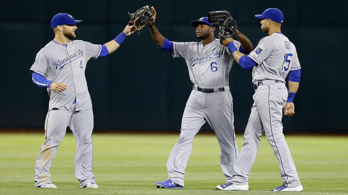 
From left, Kansas City Royals' Alex Gordon, Lorenzo Cain, and Alex Rios celebrate a 5-2 defeat of the Oakland Athletics in a baseball game Friday, June 26, 2015, in Oakland, Calif. 

