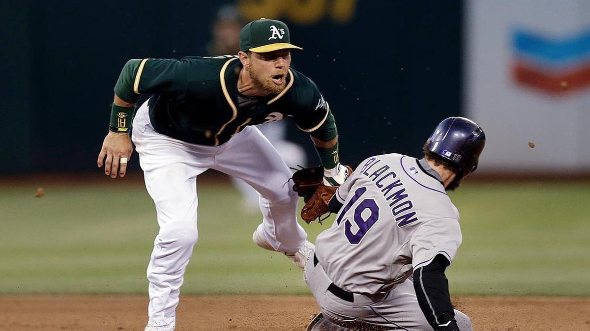 
Oakland’s Ben Zobrist tagged out the Rockies’ Charlie Blackmonon on an attempted steal of second base on June 30, 2015, in Oakland, Calif. 
