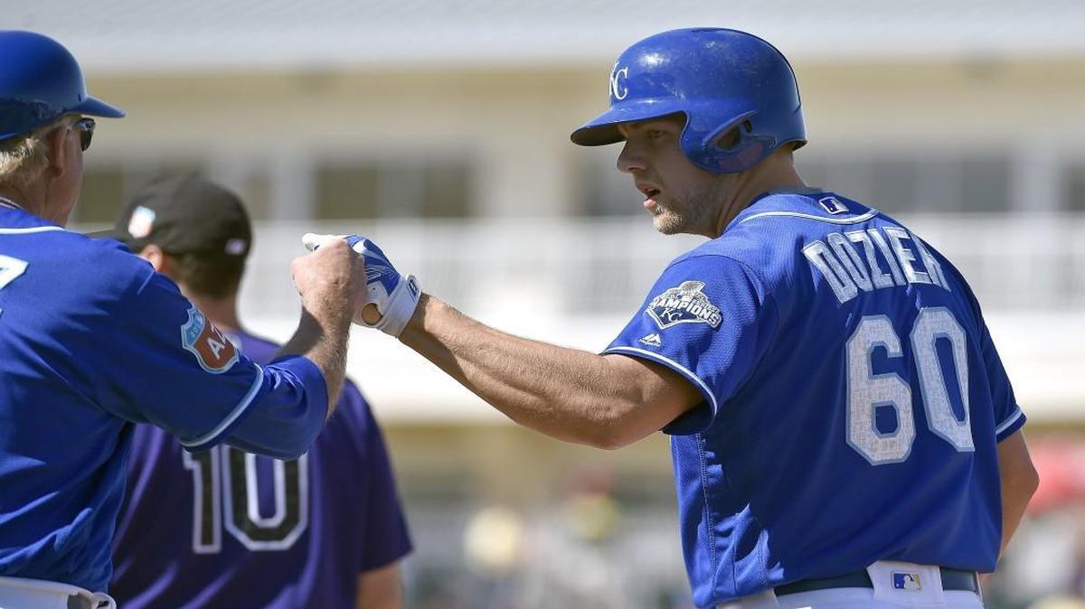 Hunter Dozier was congratulated by first-base coach Rusty Kuntz after a single in the fifth inning during spring training.