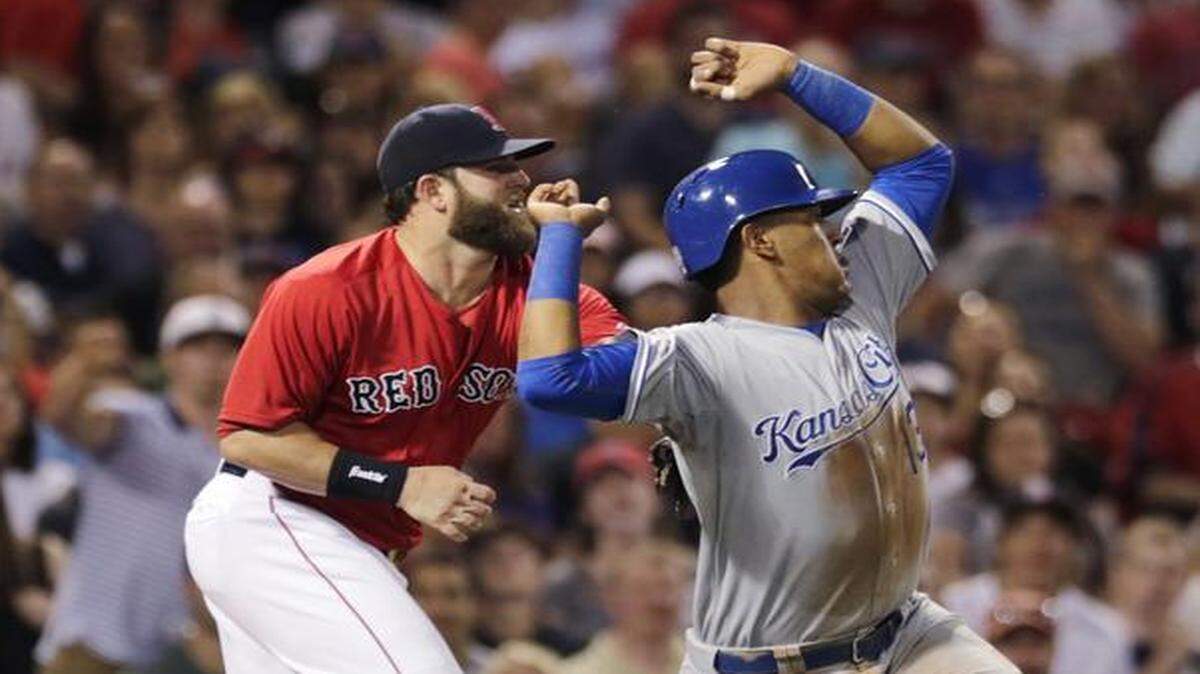 
The Royals' Salvador Perez (right) is tagged out by Boston Red Sox first baseman Mike Napoli after being caught in a rundown while trying to score during Friday’s baseball game at Fenway Park in Boston.
