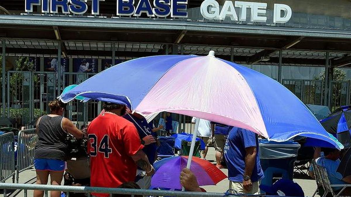 
Fans sat under umbrellas of all types as they waited for the gates to open for Saturday’s sold-out game between the Kansas City Royals and Boston Red Sox.
