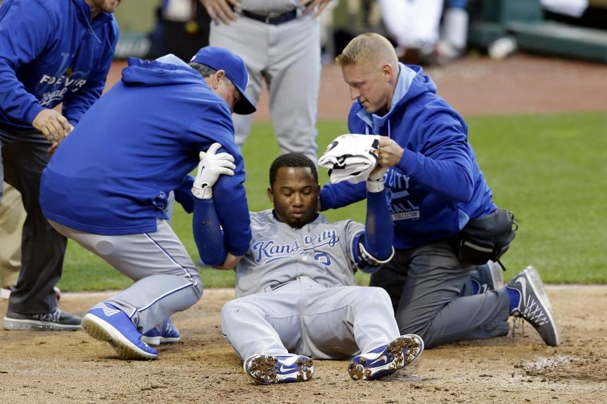 Royals shortstop Alcides Escobar was helped up by trainers after getting hit in the helmet by a pitch from Cleveland Indians starting pitcher Danny Salazar in the fifth inning April 29, 2015, in Cleveland. 