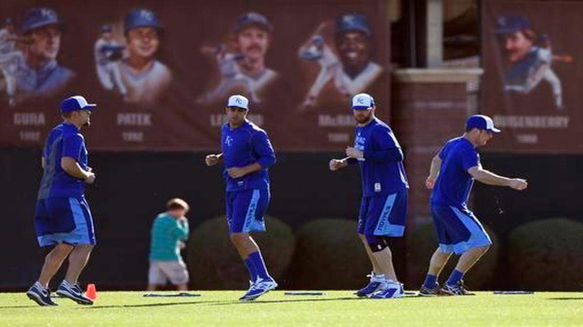 
Royals pitchers warmed up during a voluntary workout Wednesday before the start of spring training in Surprise, Ariz.
