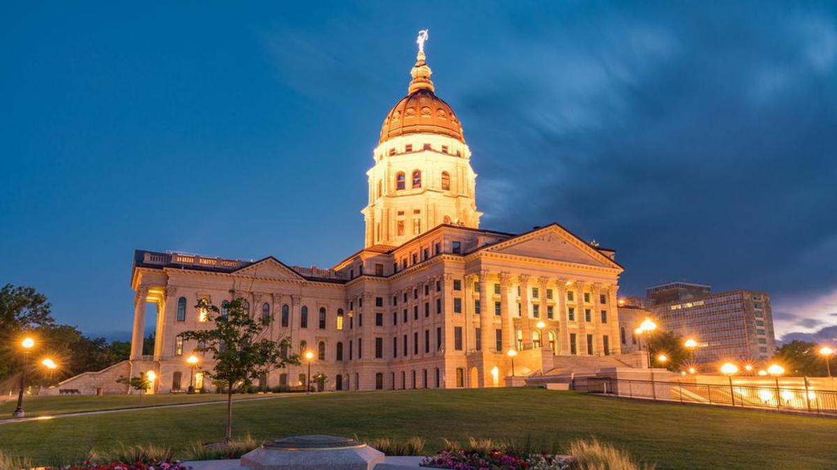 The exterior of the Kansas State Capital Building in Topeka is seen at night.