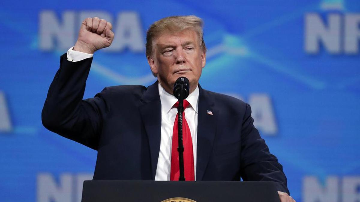 FILE - In this April 26, 2019, file photo, President Donald Trump speaks at the National Rifle Association Institute for Legislative Action Leadership Forum in Lucas Oil Stadium in Indianapolis. The NRA sued San Francisco on Monday, Sept. 9, 2019, over the city’s recent declaration that the gun-rights lobby is a “domestic terrorist organization.” Democrat leaders in Congress on Monday urged Trump, a favorite of the NRA, to push Republicans to agree to expand background checks, and there have been efforts to make it easier to seize firearms at least temporarily from people who are exhibiting mental health issues. (AP Photo/Michael Conroy, File)