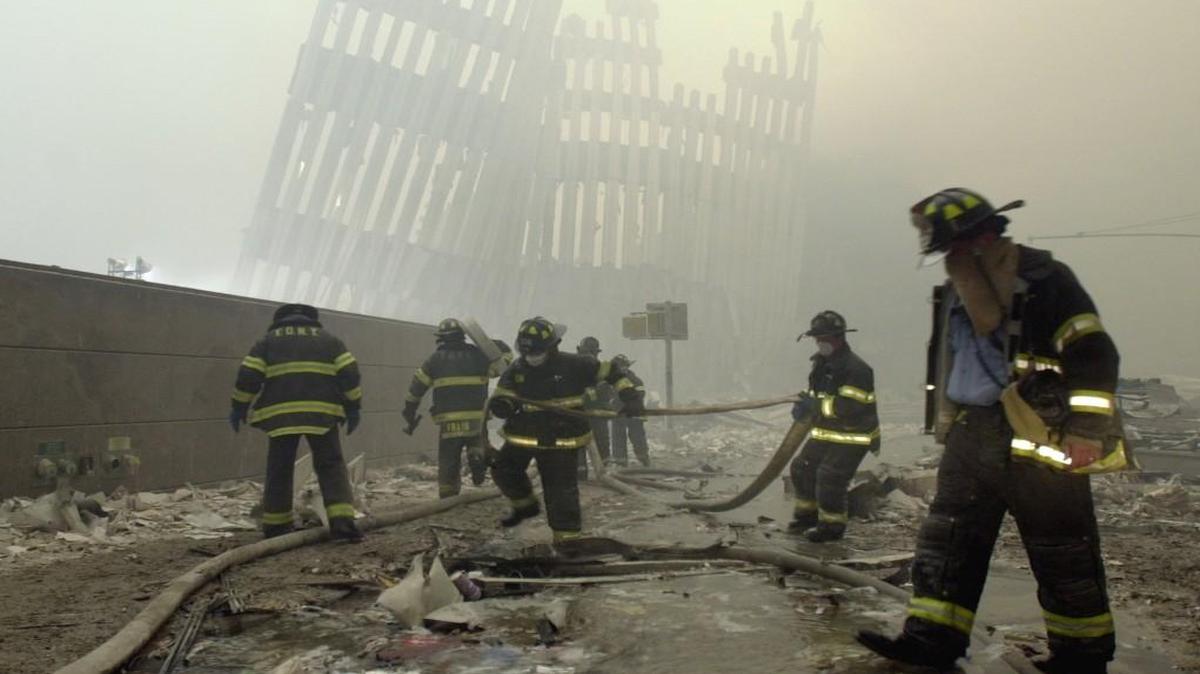 In this 2001 file photo, firefighters work beneath the destroyed mullions, the vertical struts which once faced the soaring outer walls of the World Trade Center towers, after a terrorist attack on the twin towers in New York.