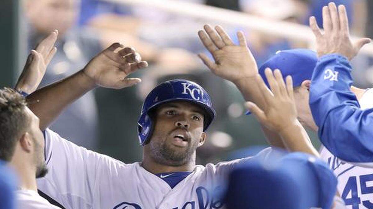 
The Royals’ Carlos Peguero (34) was congratulated after scoring on a single by Mike Moustakas in the fourth inning during Monday’s game against the Texas Rangers at Kauffman Stadium.
