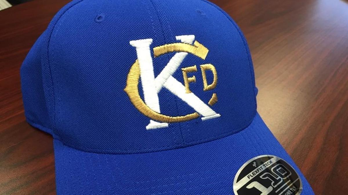 
Cumpy’s T-Shirt Shop owner Andrew Romano knew the two Kansas City Fire Department firefighters, Larry J. Leggio and John V. Mesh, who died Monday in the line of duty. He designed a special “KCFD” hat that Royals players will wear in tribute during batting practice before Wednesday’s ALDS Game 5 against the Houston Astros.

