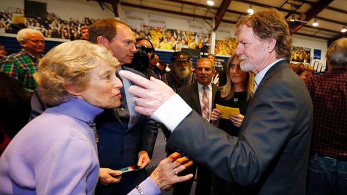 Jack Phillips, right, owner of Masterpiece Cake, confers with a supporter after a rally on the campus of a Christian college in Lakewood, Colo. Phillips is at the center of a case that may determine if business owners like Phillips are having their right of religious liberty and free expression violated by having to offer their wedding services to same-sex couples.