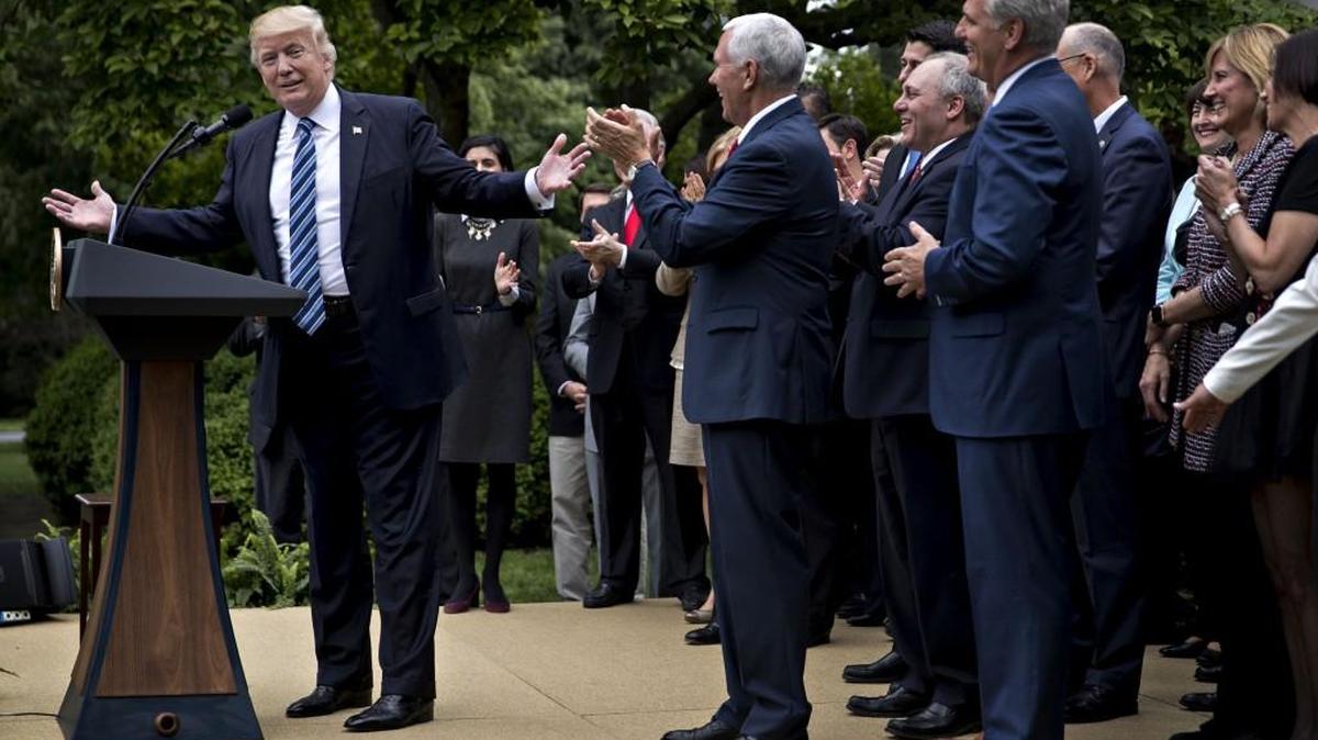 President Donald Trump, left, speaks during a press conference with House Republicans in the Rose Garden of the White House in Washington, D.C., U.S., on Thursday, May 4, 2017. Republicans mustered just enough votes to pass their health care bill.