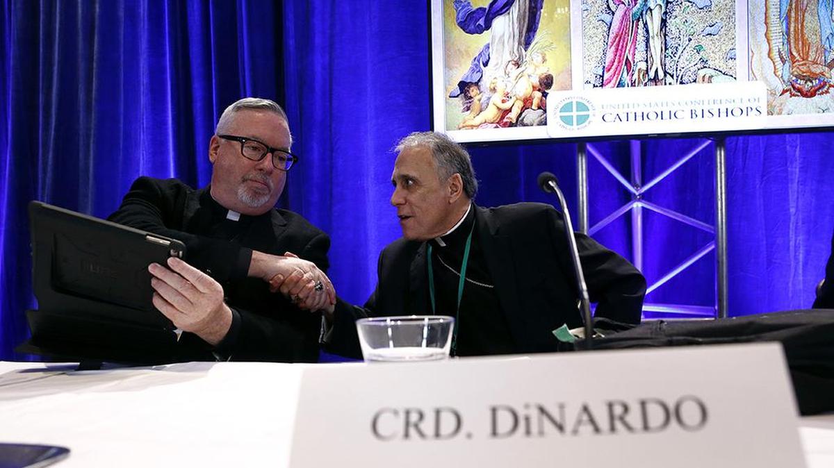 Cardinal Daniel DiNardo of the Archdiocese of Galveston-Houston, right, president of the United States Conference of Catholic Bishops, shakes hands with Bishop Christopher Coyne of Burlington, Vt.