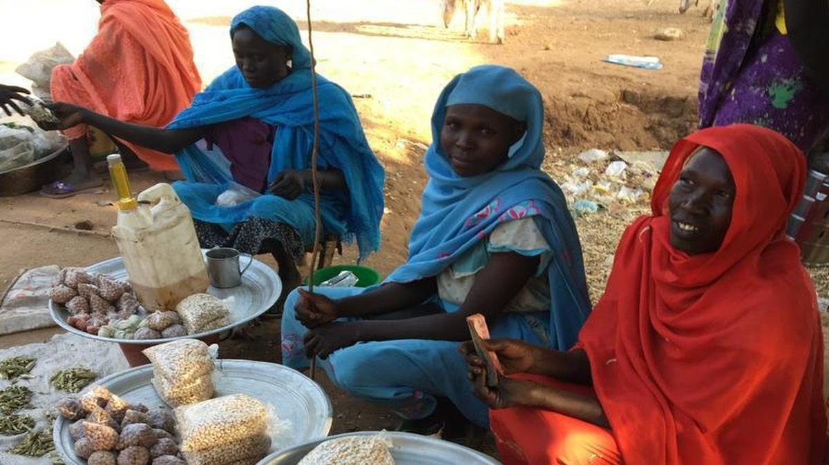 Women selling peanuts and dried chili peppers in the market are confident that President Donald Trump is going to stand up for them against the war criminal who runs their country. “We are tired of war,” says Saadia Muhammed (right). “We don’t want these bombs to drop on our heads.”