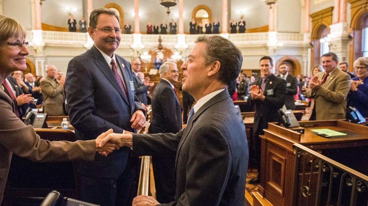 Kansas Gov. Sam Brownback walks into the House chamber to deliver his last State of the State speech.