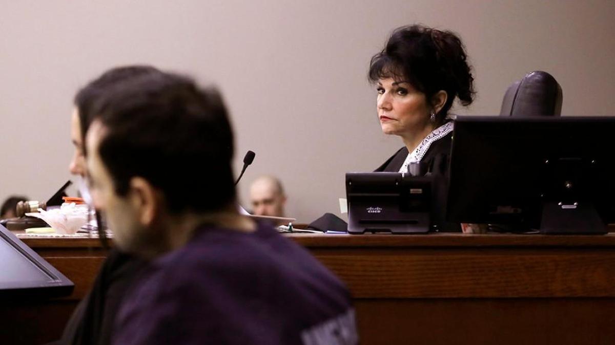 Judge Rosemarie Aquilina looks towards Larry Nassar as a victim gives her impact statement during the seventh day of Larry Nassar's sentencing hearing Wednesday, Jan. 24, 2018, in Lansing, Mich.