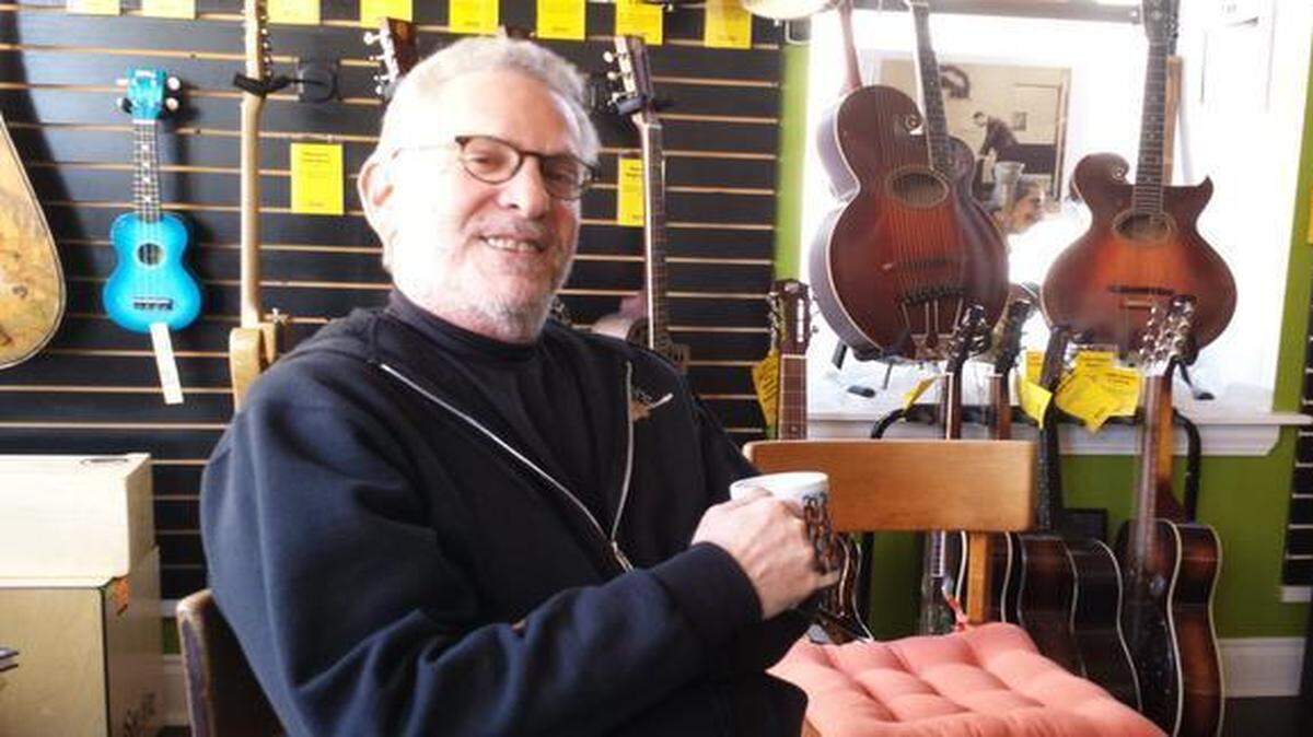 
Louis Meyers, special projects coordinator for Folk Alliance International, is surrounded by vintage guitars and other instruments at the Folk Store, 509 Delaware St.
