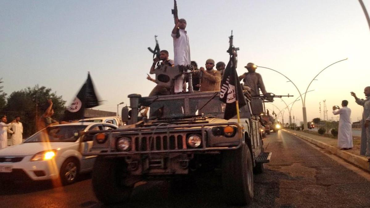 In June 2014, fighters from the Islamic State group paraded in a commandeered Iraqi security forces armored vehicle down a main road at the northern city of Mosul, Iraq.