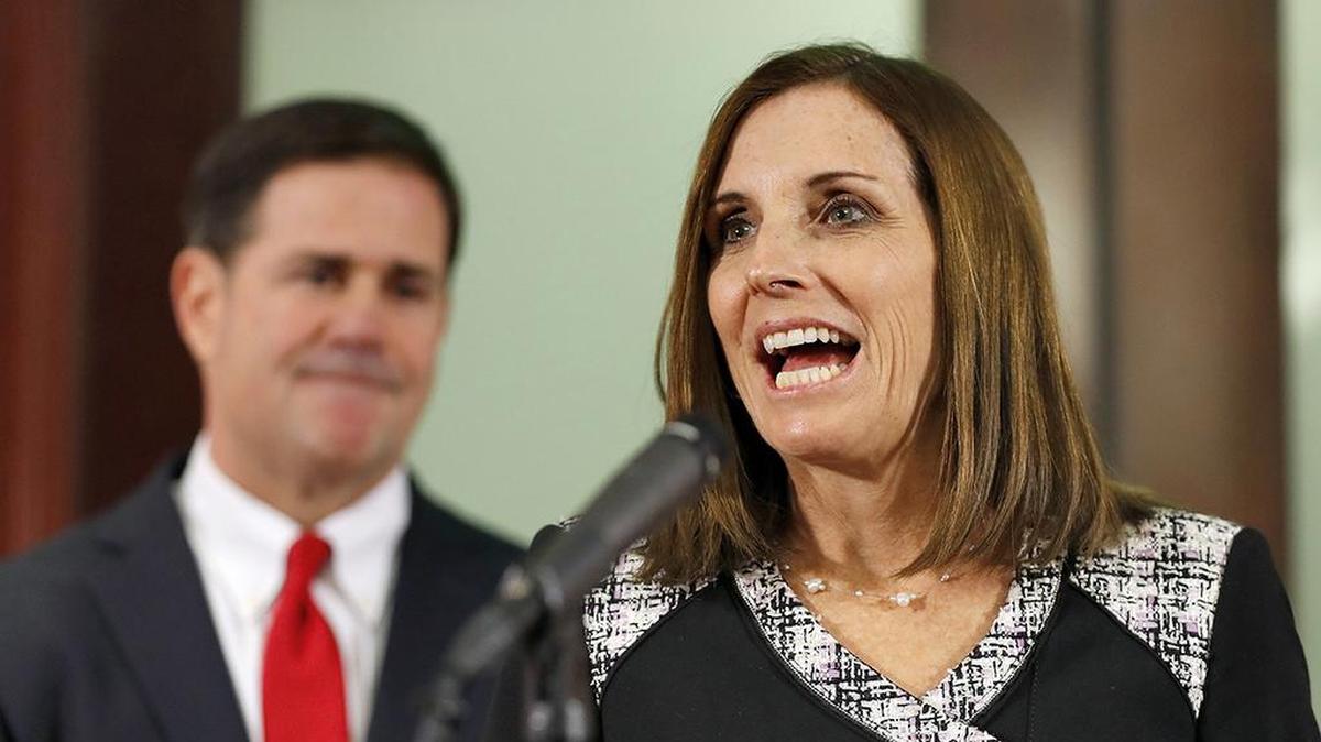 U.S. Rep. Martha McSally speaks during a news conference Dec. 18 after Arizona Gov. Doug Ducey, rear, announced his decision to replace U.S. Sen. Jon Kyl, R-Ariz. with McSally in the U.S. Senate seat that belonged to Sen. John McCain.