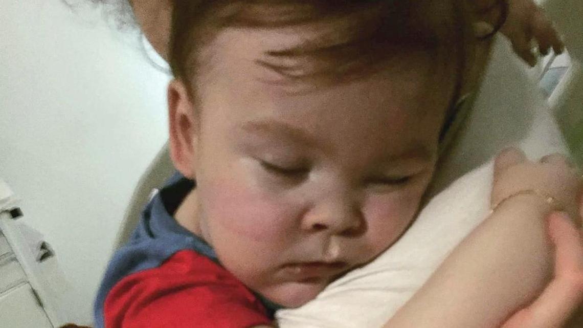 In this April 23, 2018 handout photo, brain-damaged toddler Alfie Evans cuddles his mother Kate James at Alder Hey Hospital, Liverpool, England.