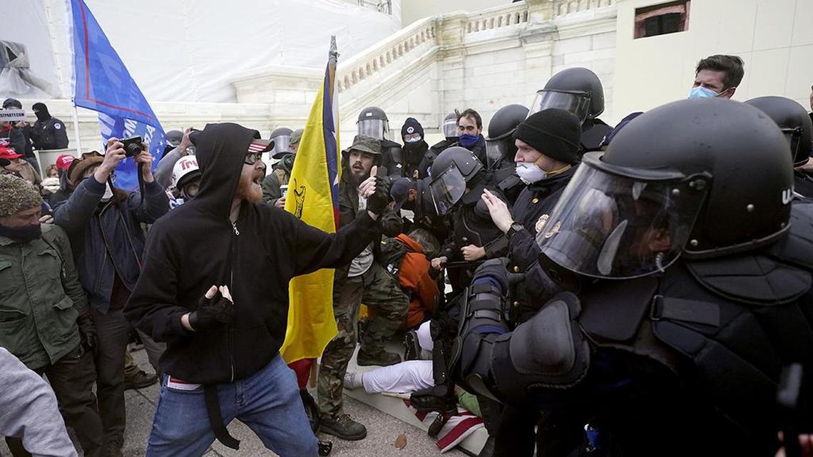 Trump supporters try to break through a police barrier, Wednesday, Jan. 6, 2021, at the Capitol in Washington. As Congress prepares to affirm President-elect Joe Biden’s victory, thousands of people have gathered to show their support for President Donald Trump and his claims of election fraud. (AP Photo/Julio Cortez)