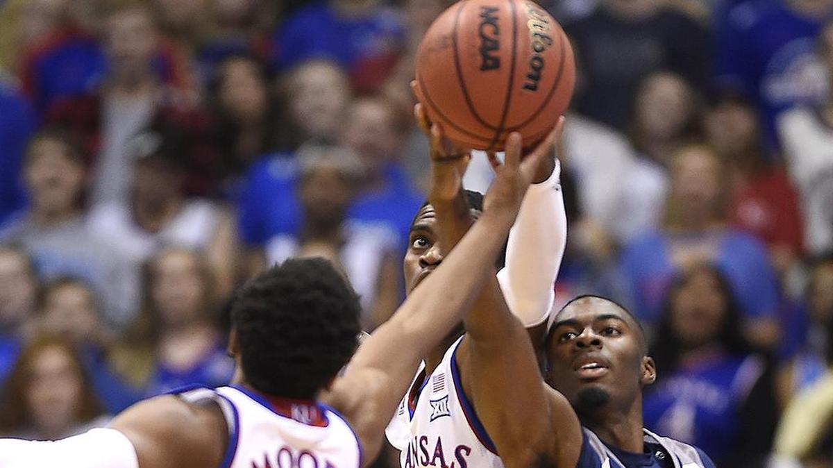 KU teammates Charlie Moore, left, and Lagerald Vick, rear, battle Washburn’s Tyas Martin for a rebound during the first half of the Jayhawks final exhibition game Nov. 1, 2018, at Allen Fieldhouse.