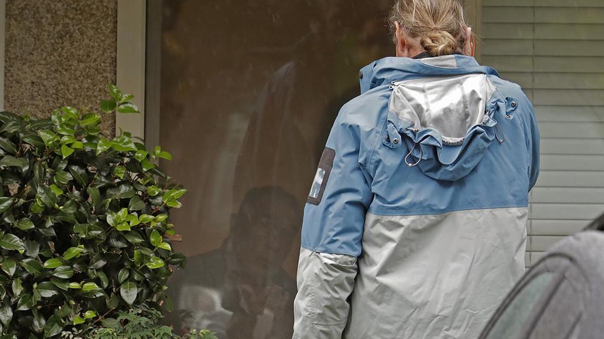 In this March 6 photo, Gene Campbell, left, watches through his window as he talks with his son, Charlie, foreground, using a phone at the Life Care Center in Kirkland, Washington. In mid-March, Charlie, 61, tried his first online Alcoholics Anonymous meeting. His internet was shaky and he didn't get to speak. The meeting did not give him the peace and serenity he craved. “I’m a face-to-face kind of person,” he said. Still, he hasn't relapsed.