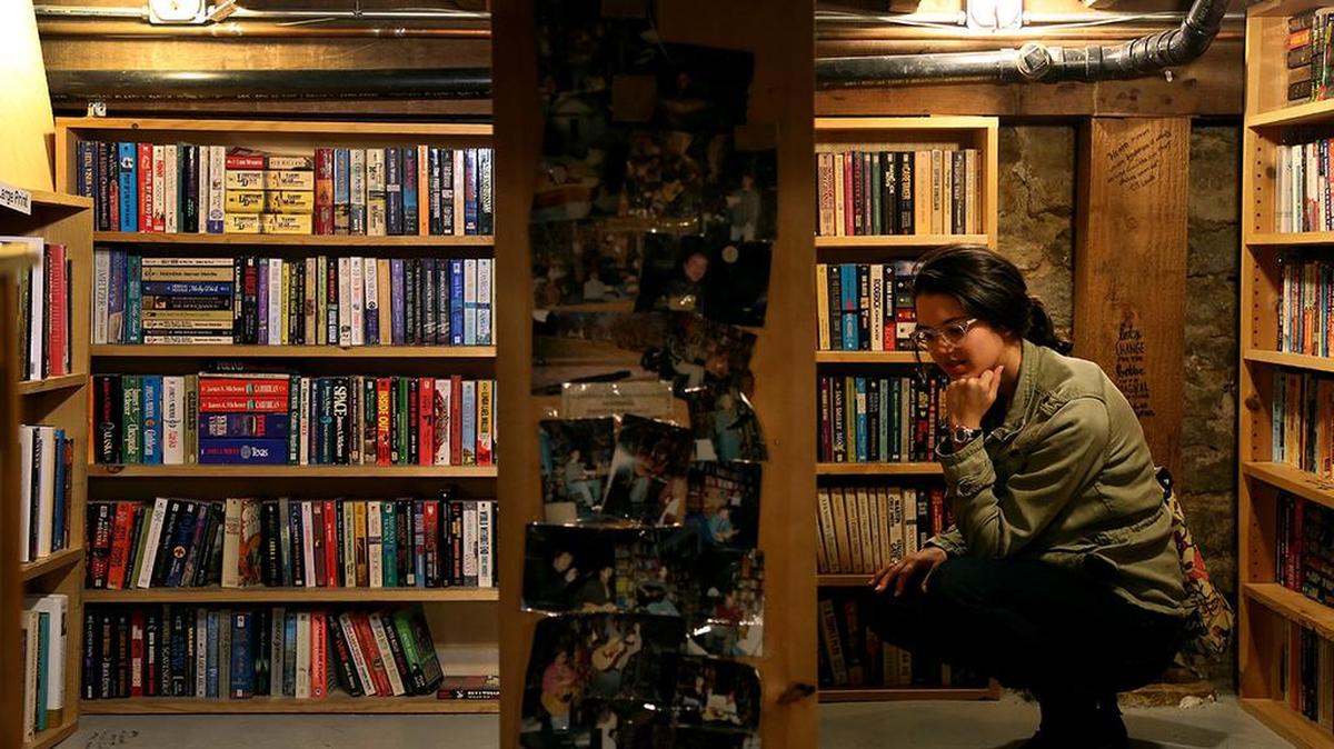 In this 2018 file photo, Samantha Gibbs browses in the basement of Prospero’s Bookstore on West 39th Street in Kansas City.