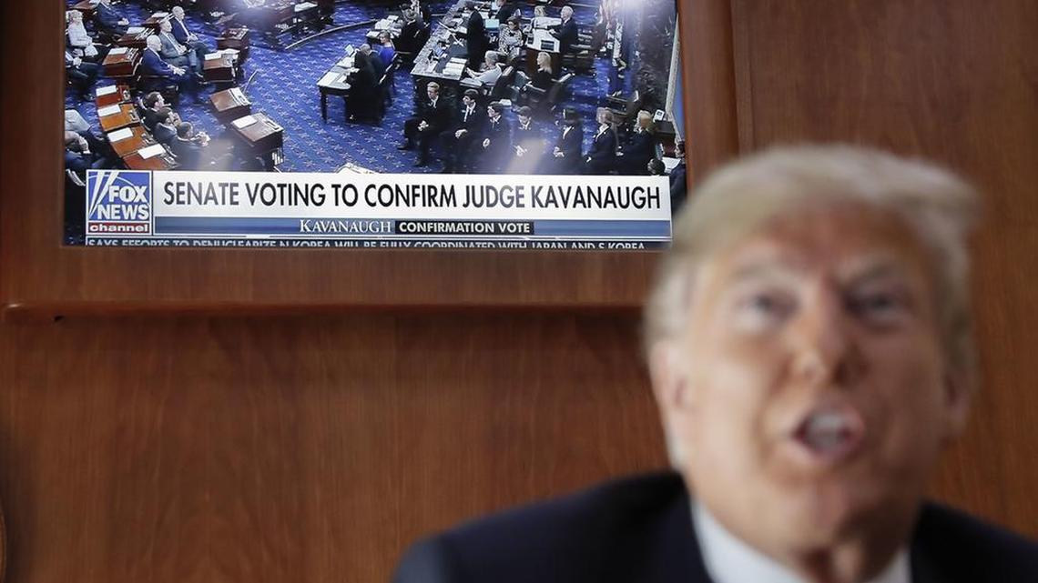 A live television broadcast of the Senate confirmation vote of Supreme Court nominee Brett Kavanaugh played behind President Donald Trump on Air Force One as he traveled to Topeka, Kan., for a campaign rally.