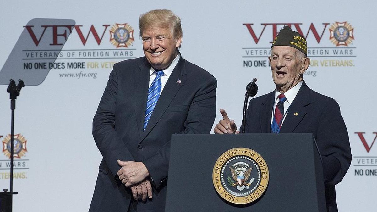 President Donald Trump greeted World War II Army veteran Allen Jones, 94, of Collinsville, Penn., on stage at the Veterans of Foreign Wars National Convention during a stop in Kansas City Tuesday at Municipal Auditorium.
