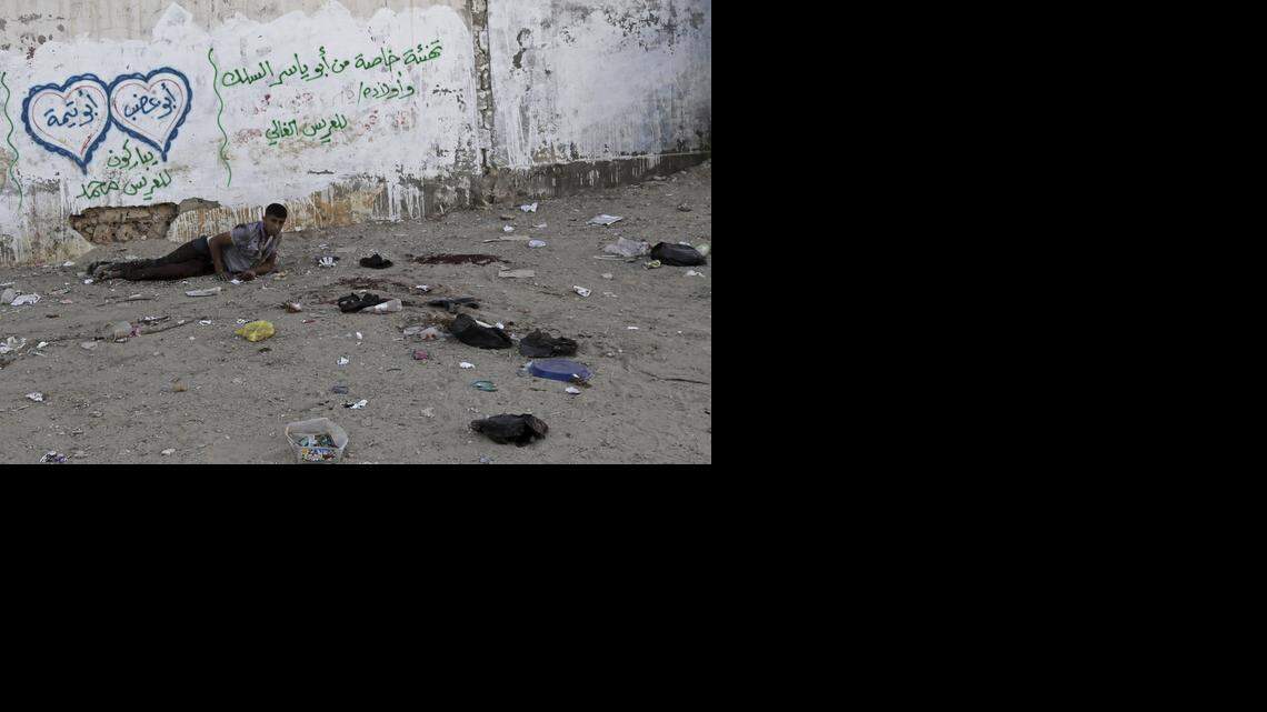 
An injured Palestinian man lay on the ground Wednesday next to a wall that had wedding greetings graffiti as he waited for help following an Israeli strike in the Shijaiyah neighborhood in eastern Gaza City.
