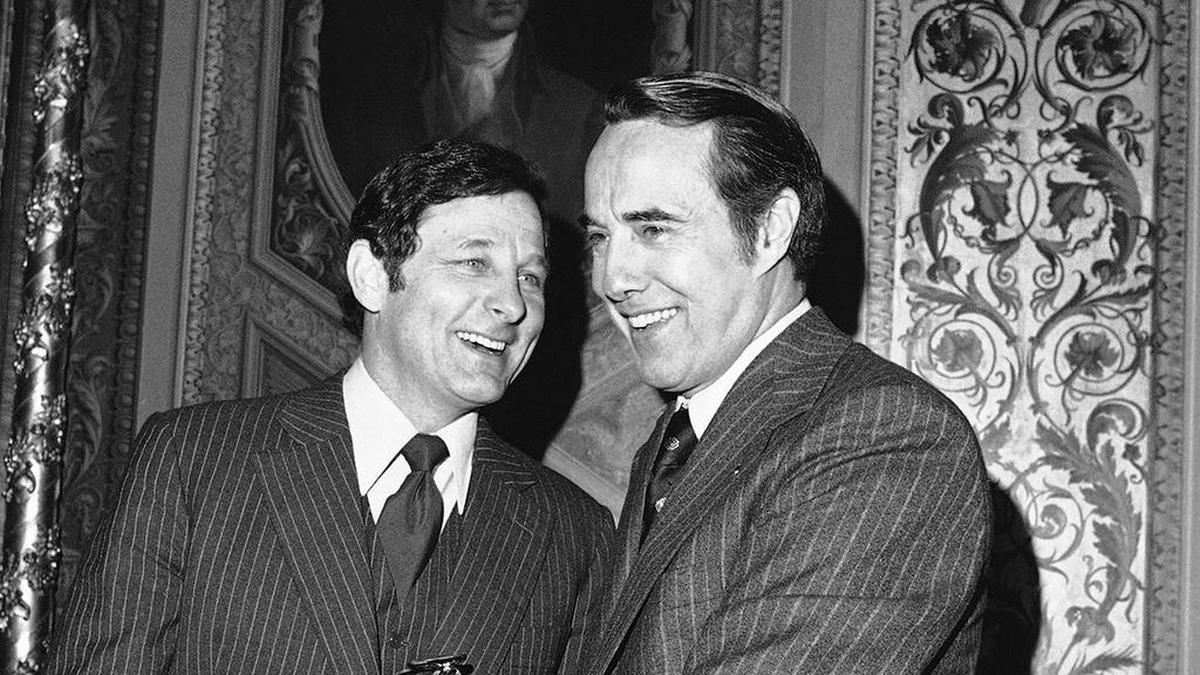 Sen. Birch Bayh, D-Ind., and Sen. Bob Dole, R-Kan., right, get together on Tuesday, Feb. 21, 1978 at the Capitol during a break in a closed session of the Senate that is discussing the Panama Canal treaties. Dole said he would move to make public charges involving Gen. Torrijos and members of his family being involved in drug traffic. Bayh, as chairman of the Senate Intelligence Committee, has custody of classified files dealing with the allegations. (AP Photo/ John Duricka)