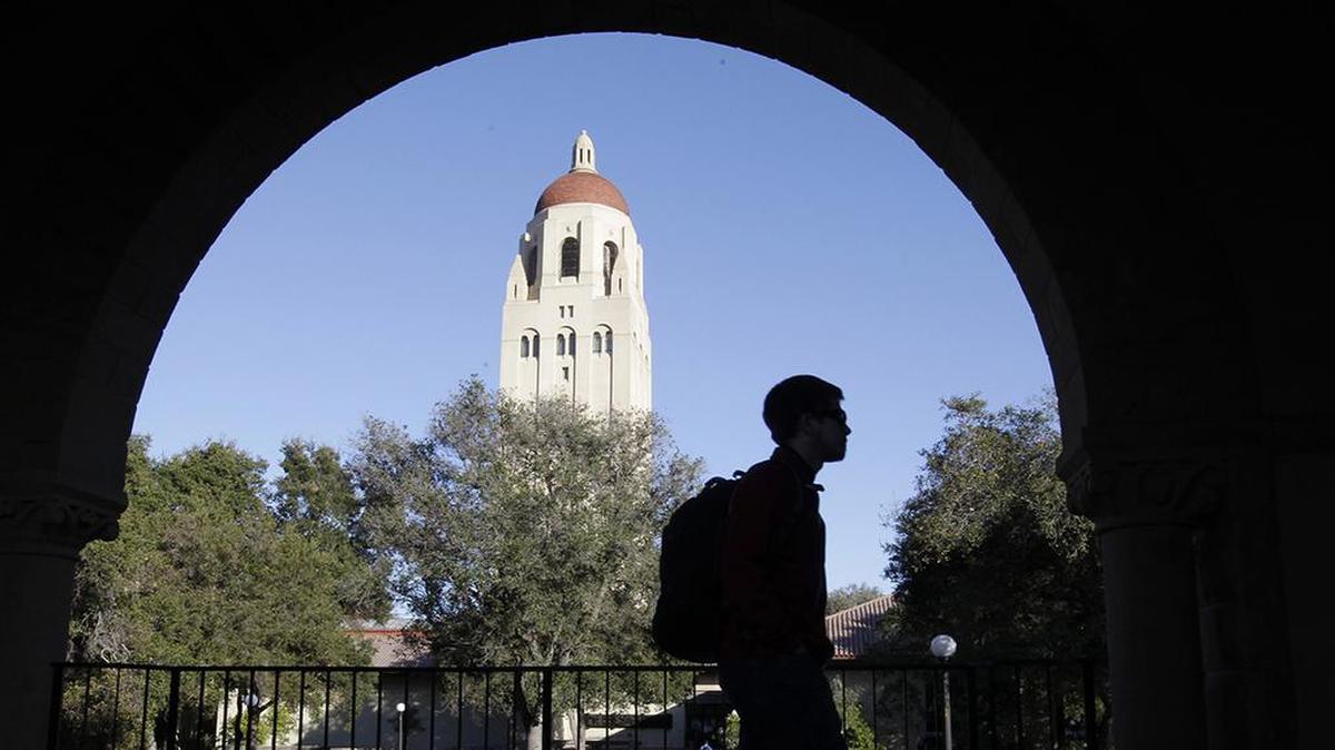 In this Wednesday, Feb. 15, 2012 file photo, a Stanford University student walks in front of Hoover Tower on the Stanford University campus in Palo Alto, Calif. (AP Photo/Paul Sakuma, File)