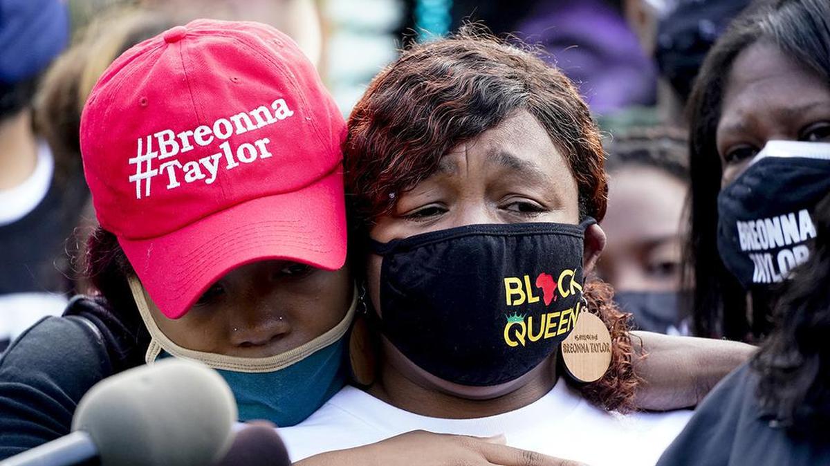 Tamika Palmer, the mother of Breonna Taylor, right, listens to a news conference, Friday, Sept. 25, 2020, in Louisville, Ky. (AP Photo/Darron Cummings)