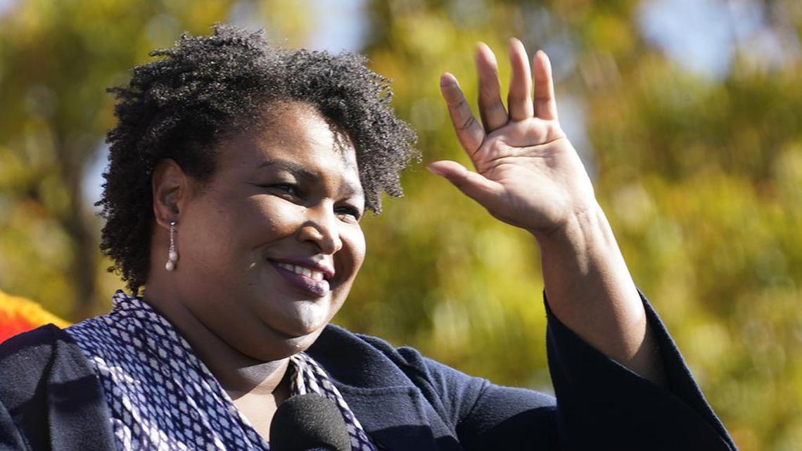 A football coach fired by the University of Tennessee-Chattanooga over a tweet about Stacey Abrams has sued the college.