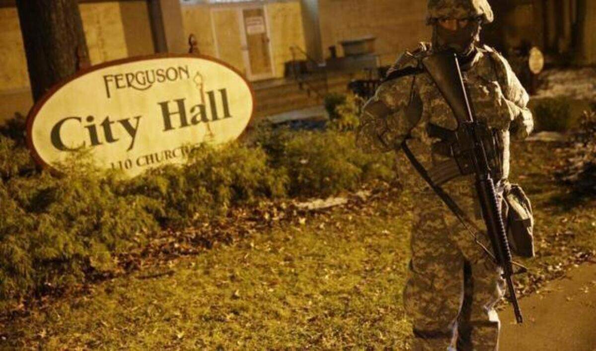 
A Missouri National Guardsman in November stood in front of Ferguson City Hall. The suburb of St. Louis has not been eager to share documents in the aftermath of the fatal Ferguson police shooting on Aug. 9 of unarmed 18-year-old Michael Brown. Ongoing protests, many of them violent, have resulted in property damage, arrests and two police officers on Thursday being shot.
