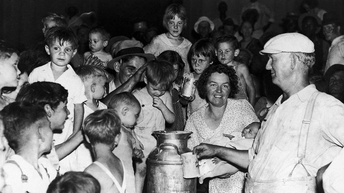 During the great depression, rioting farmers dumped cans of milk rather than sell for two cents a quart. In this image babies and small children of relief workers in Kansas City, United States, protest cuts in funds in the Wyandotte county court house on August 7, 1930. During this dark period in American history, millions of people could not afford butter at 39 cents a pound or roast at 21 cents.