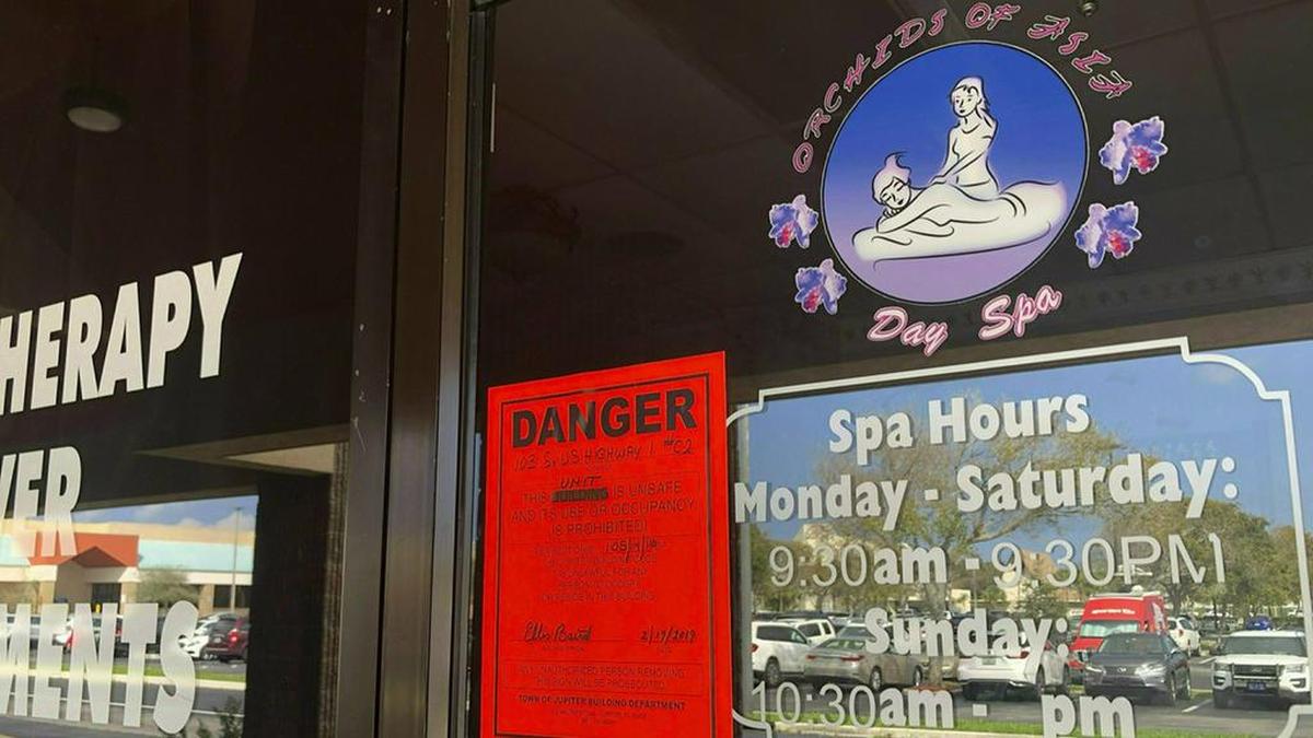 FILE - In this Feb. 19, 2019, file photo, a sign is posted outside of Orchids of Asia Day Spa in Jupiter, Fla., one of several spas closed in south Florida as a result of a six-month investigation into sex trafficking. The Florida prostitution sting that ensnared New England Patriots owner Robert Kraft is a reminder of the human trafficking and abuse taking place behind the darkened windows of many of these storefronts, and how challenging those problems can be to address. (Hannah Morse/Palm Beach Post via AP, File)