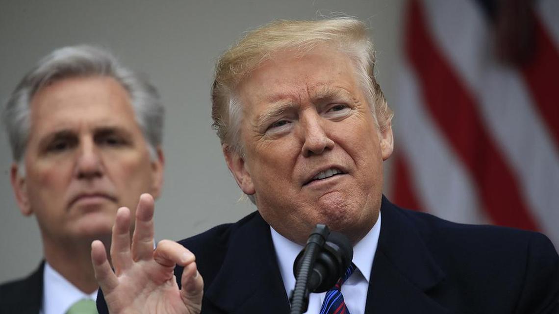 House Minority Leader Kevin McCarthy, left, listens to President Donald Trump.