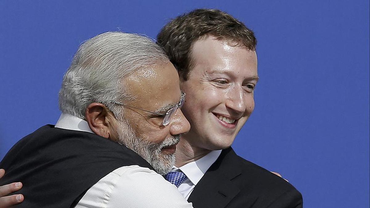 Facebook CEO Mark Zuckerberg, right, hugs Indian Prime Minister Narendra Modi, whose Bharatiya Janata Party used Facebook to “rile up anti-Muslim passions and channel people to the polls”