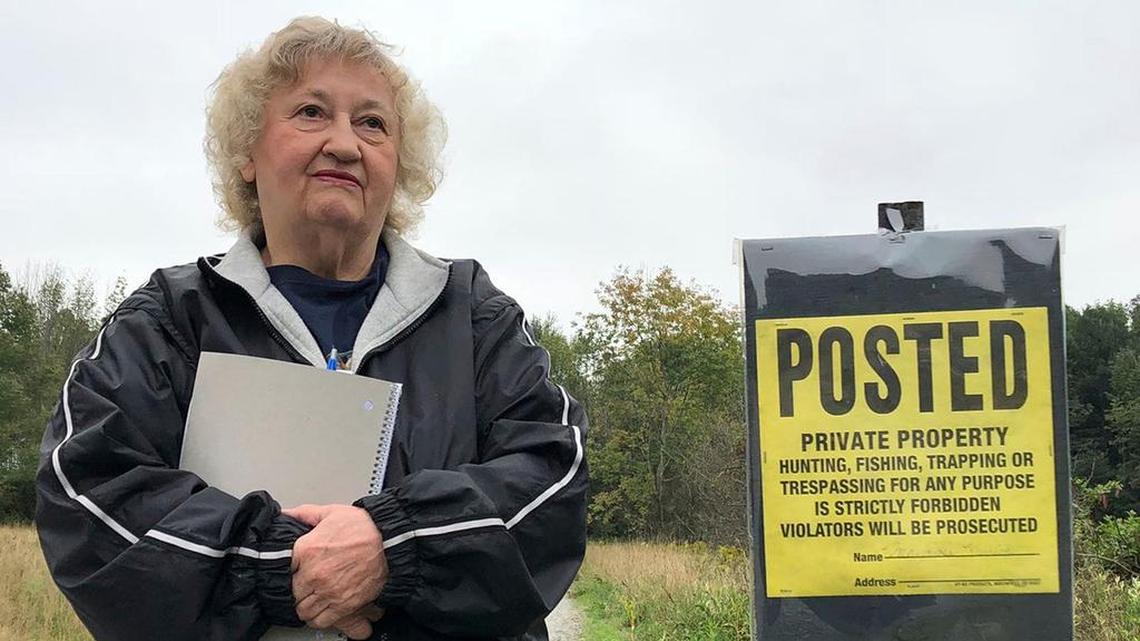 Rose Mary Knick stands next to a private property sign on her farmland in Scott Township in Pennsylvania’s Lackawanna County on Sept. 21, 2018.