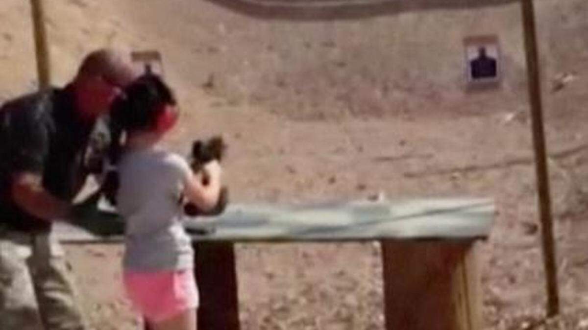 
This image, made from video provided by the Mohave County Sheriff’s Department, shows firing-range instructor Charles Vacca (left) showing a 9-year old girl how to use an Uzi. Vacca, 39, was standing next to the girl last week at the Last Stop range in Arizona when the girl squeezed the trigger, causing the Uzi to recoil upward and fatally shoot Vacca in the head. 
