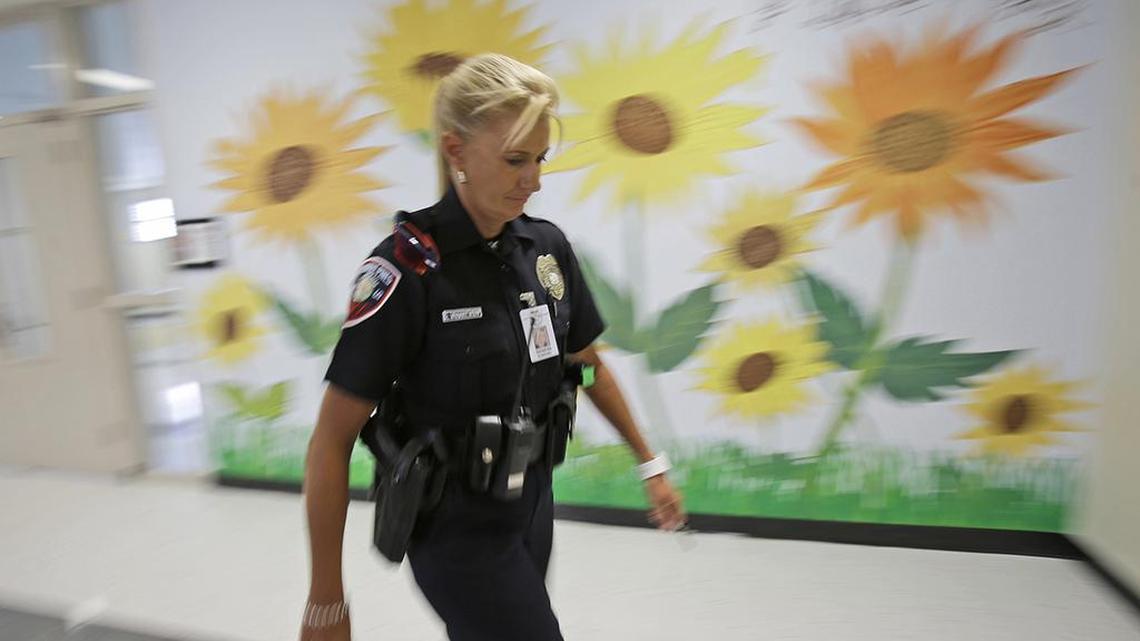 A resource officer walks through an elementary school in Pembroke Pines, Fla. Fort Worth’s school board is grappling with the role of school resource officers.