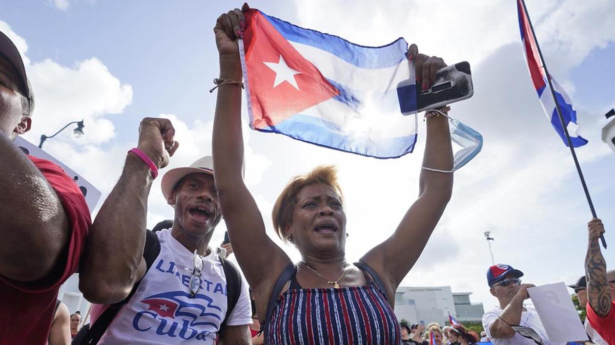 Dulce Diaz, center, and her brother Carlos Diaz, left, demonstrated July 14 in Miami's Little Havana neighborhood, as people rallied in support of demonstrations in Cuba.
