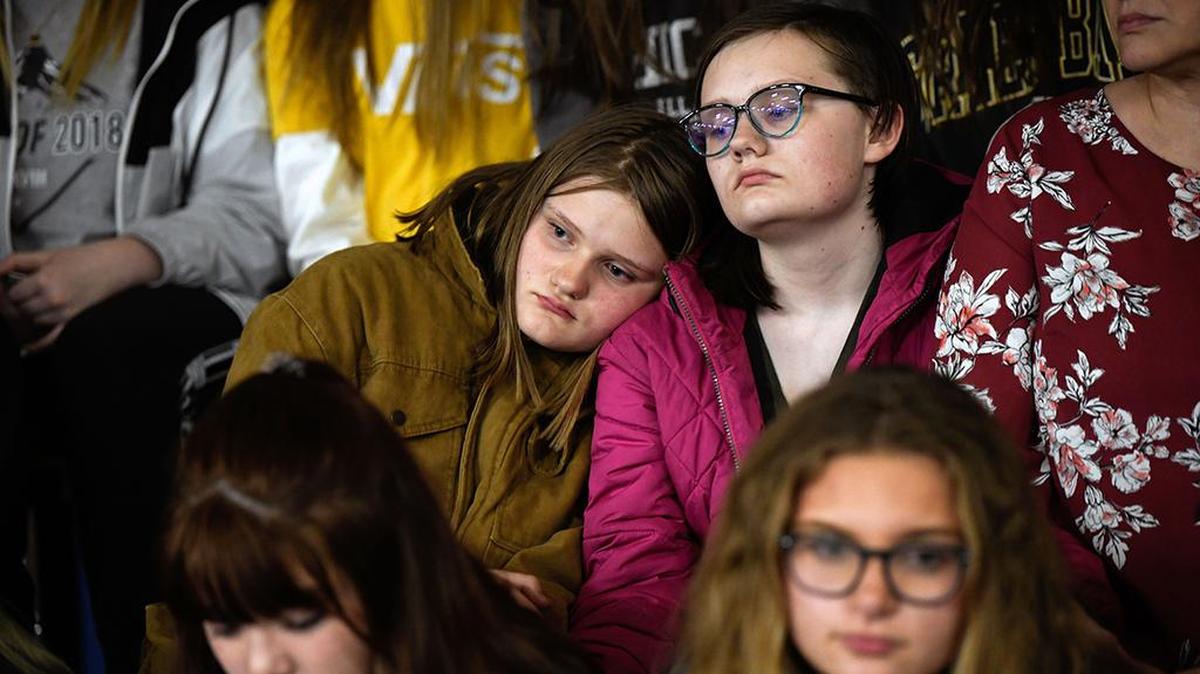 From left, sisters Rachel, 13, and Katie Newman, 15, embrace on Wednesday, May 8, 2019, during a vigil in Highlands Ranch, Colo., for the victims of the school shooting on Tuesday afternoon which left one student dead and eight others injured. Kendrick Castillo, a gentle teenager fascinated by cars and engineering, lunged to stop the gunman and was shot dead.